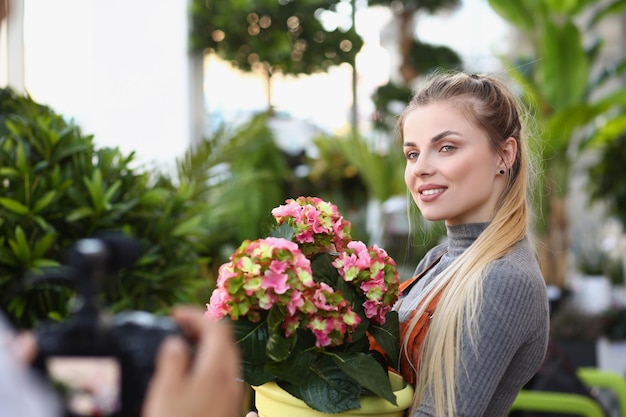 Beautiful blonde florist studio worker record promotion for botanical store