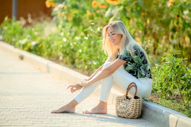 Beautiful blonde in the garden of a sunny summer day