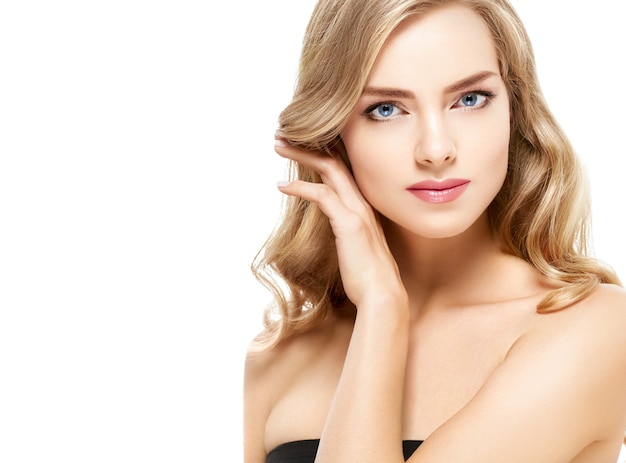 Beautiful blonde girl portrait, woman face with perfect curly hairstyle. Studio shot.