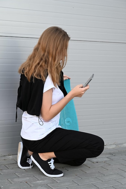 Beautiful and blonde girl practicing long board on the road