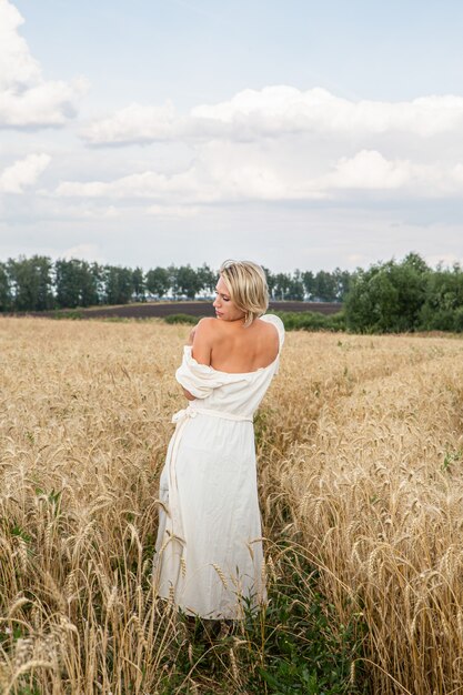 Beautiful blonde girl in a wheat field