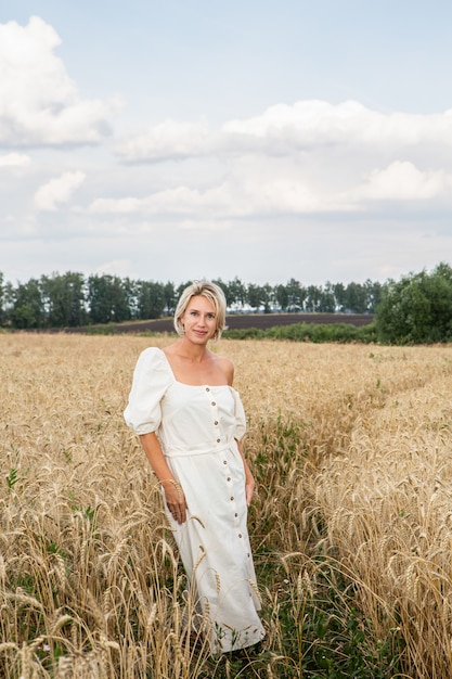 Beautiful blonde girl in a wheat field