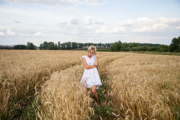 Beautiful blonde girl in a wheat field