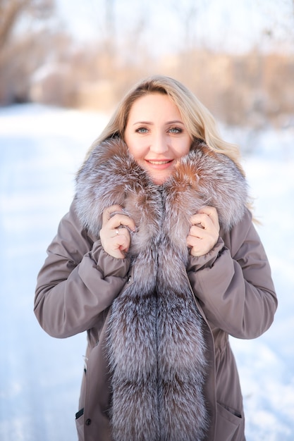 Beautiful blonde in a jacket with a fur collar