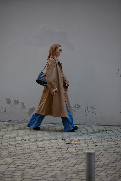 Beautiful blonde model posing on street for photo shoot