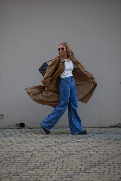 Beautiful blonde model posing on street for photo shoot