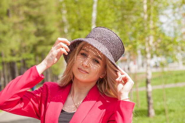 Beautiful blonde in a red jacket and hat City Style