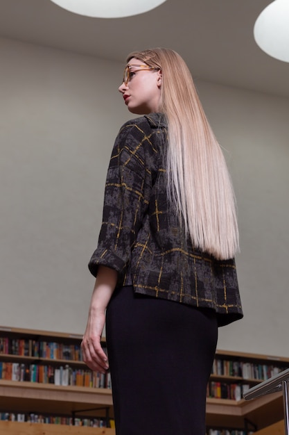 Beautiful blonde student woman posing in the learning resource centre