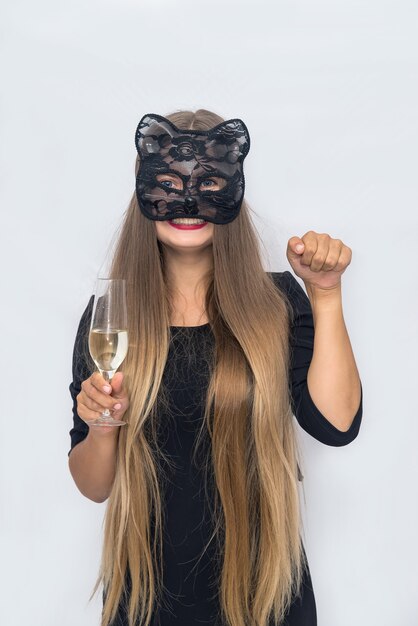 Beautiful blonde woman in carnival mask in studio