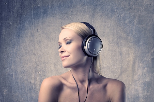 Beautiful blonde woman listening to music