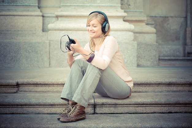 beautiful blonde woman listening to music