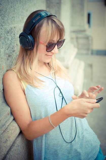 beautiful blonde woman listening to music