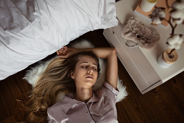 Beautiful blonde woman sleeping in pajamas at home