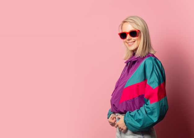 Beautiful blonde woman in sunglasses and 90s clothes