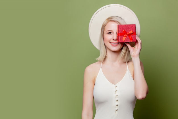 Beautiful blonde woman with red gift box