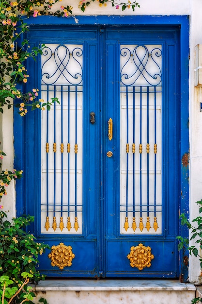 Beautiful blue door with an ornament. 