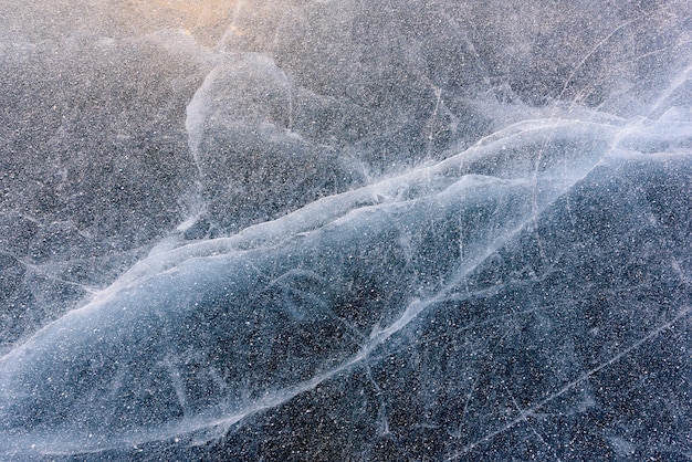 Beautiful blue ice of Lake Baikal with abstract cracks