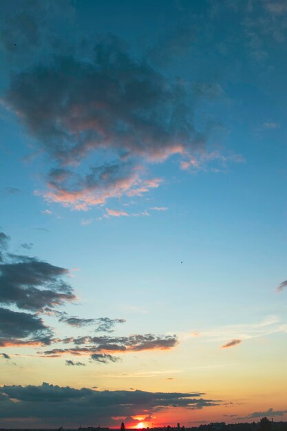 Beautiful blue sky with dark clouds Sunset evening dramatic sky Cumulus and cirrus clouds