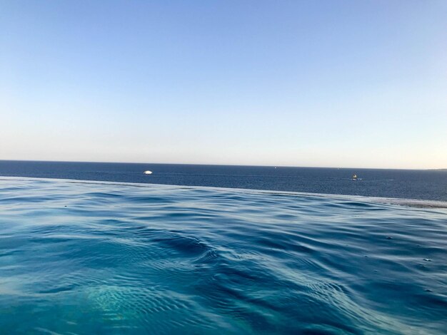 Beautiful blue wet azure natural clear water against a blue sky and horizon line in a tropical