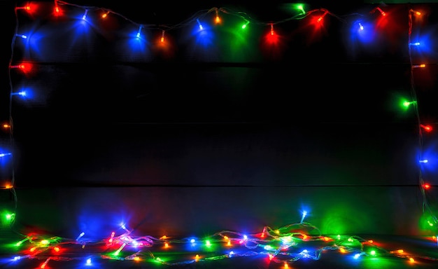 beautiful blurred christmas with a lot of colorful lights on wooden desk