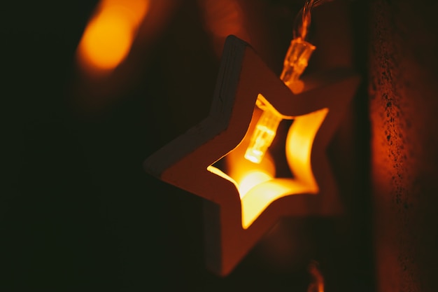 Beautiful bokeh light of star shaped garland in the dark