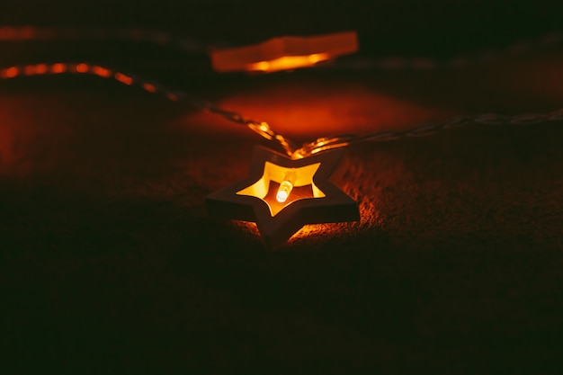 Beautiful bokeh light of star shaped garland in the dark