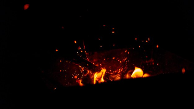 Beautiful bonfire with logs and sparks at night Fire