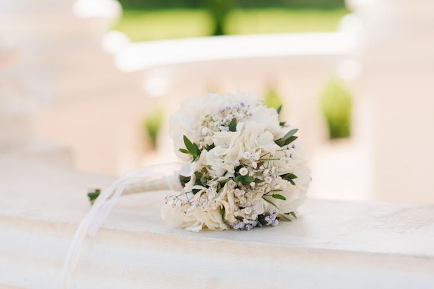 Beautiful bouquet of the bride in white with greenery