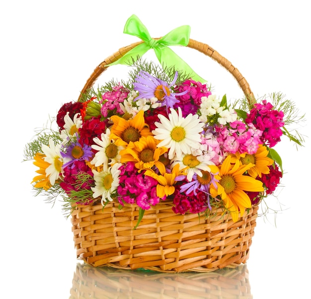 Beautiful bouquet of bright wildflowers in basket isolated on white