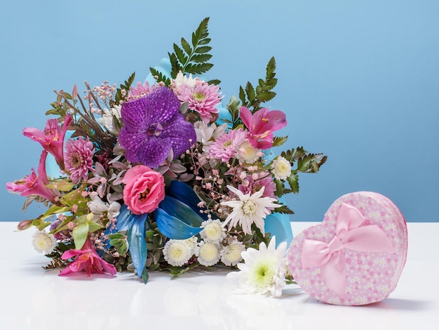 Beautiful bouquet of different flowers with gift box.