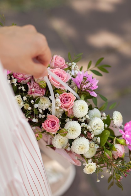 A beautiful bouquet of flowers in a box in the hands of a girl