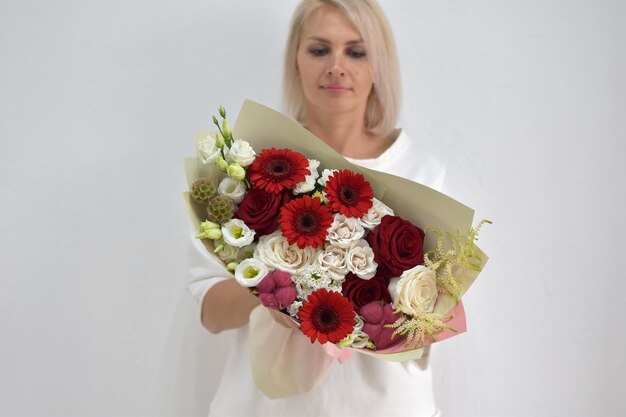 Beautiful bouquet of flowers in hands of awoman photo for postcard and catalog of an online flower shop fresh flower delivery