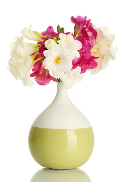 Beautiful bouquet of freesias in vase isolated on white