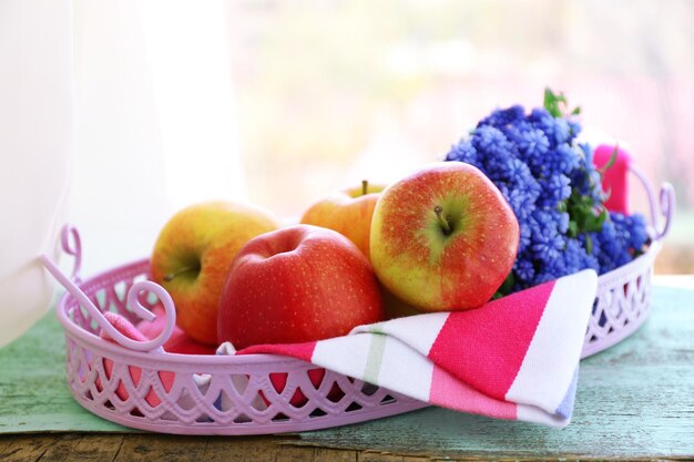 Beautiful bouquet of muscari hyacinth with fruits on metal tray on windowsill