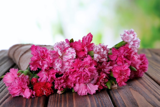 Beautiful bouquet of pink carnation on bright background