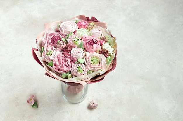 Beautiful bouquet of pink marshmallow handmade stands in a vase on a light background