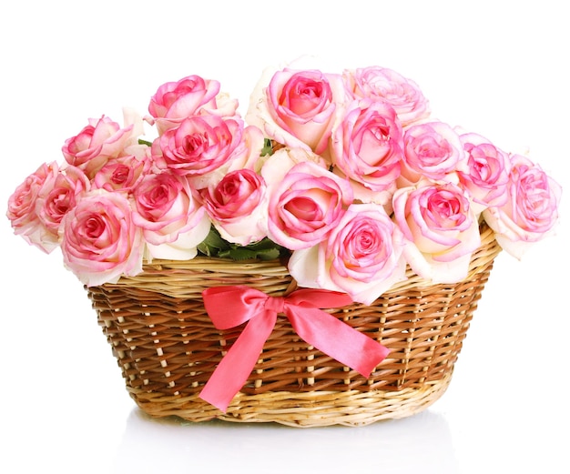 Beautiful bouquet of pink roses in basket, isolated on white