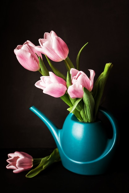A beautiful bouquet of pink tulips in a water can
