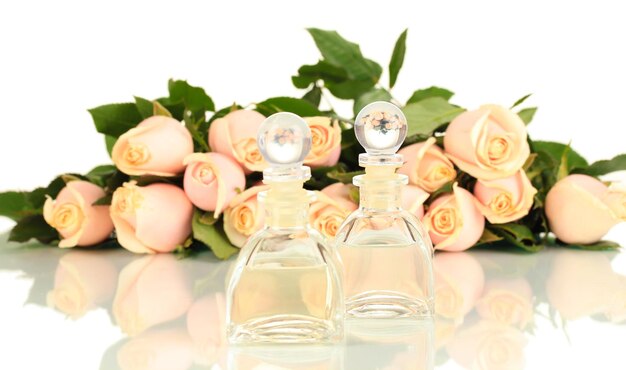 Beautiful bouquet of roses and perfume, isolated on white