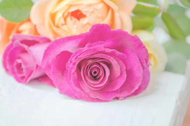 Beautiful bouquet of roses on table Flowers on white wooden background