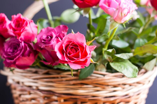 Beautiful bouquet of roses in a wicker basket.