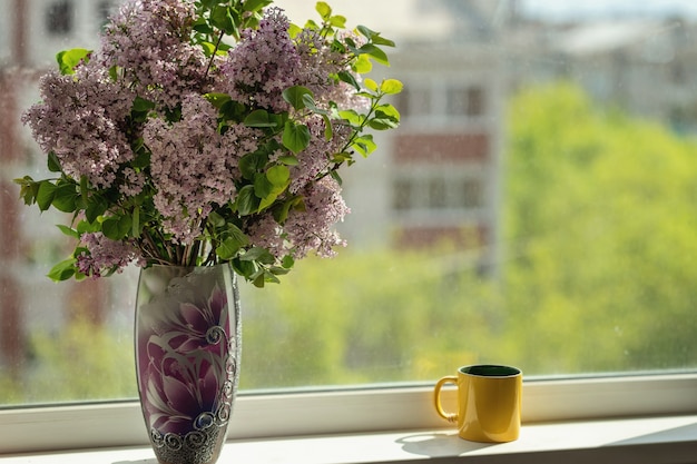 beautiful bouquet in the vase stays on the windowsill cozy home concept