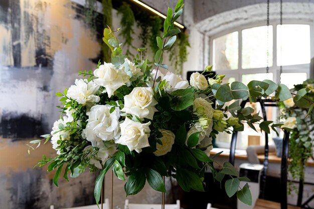 Beautiful bouquet of white roses in a vase Wedding decoration