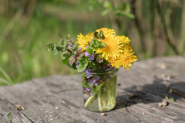 Beautiful bouquet of wildflowers in a glass jar