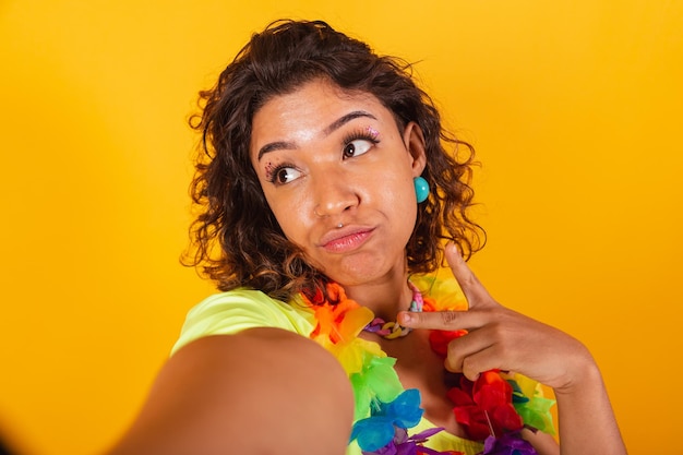 Beautiful brazilian afro american woman in carnival clothes taking selfie posing