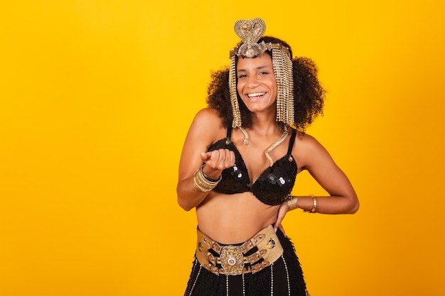 Beautiful Brazilian black woman in Cleopatra carnival clothes inviting with hands