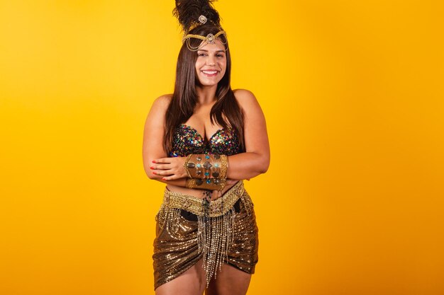 Beautiful brazilian woman in carnival clothes arms crossed smiles