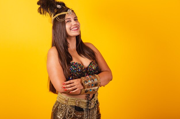 Beautiful Brazilian woman in carnival clothes arms crossed smiles