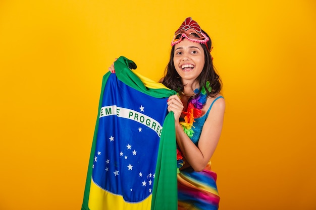 Beautiful brazilian woman in carnival clothes with flag of brazil