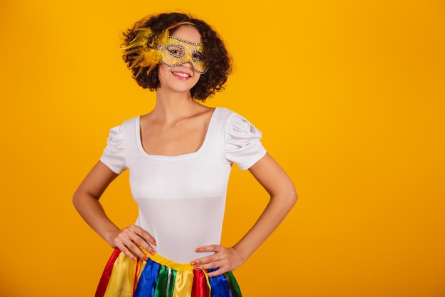 Beautiful brazilian woman dressed in carnival clothes colorful skirt and white shirt hands on waist